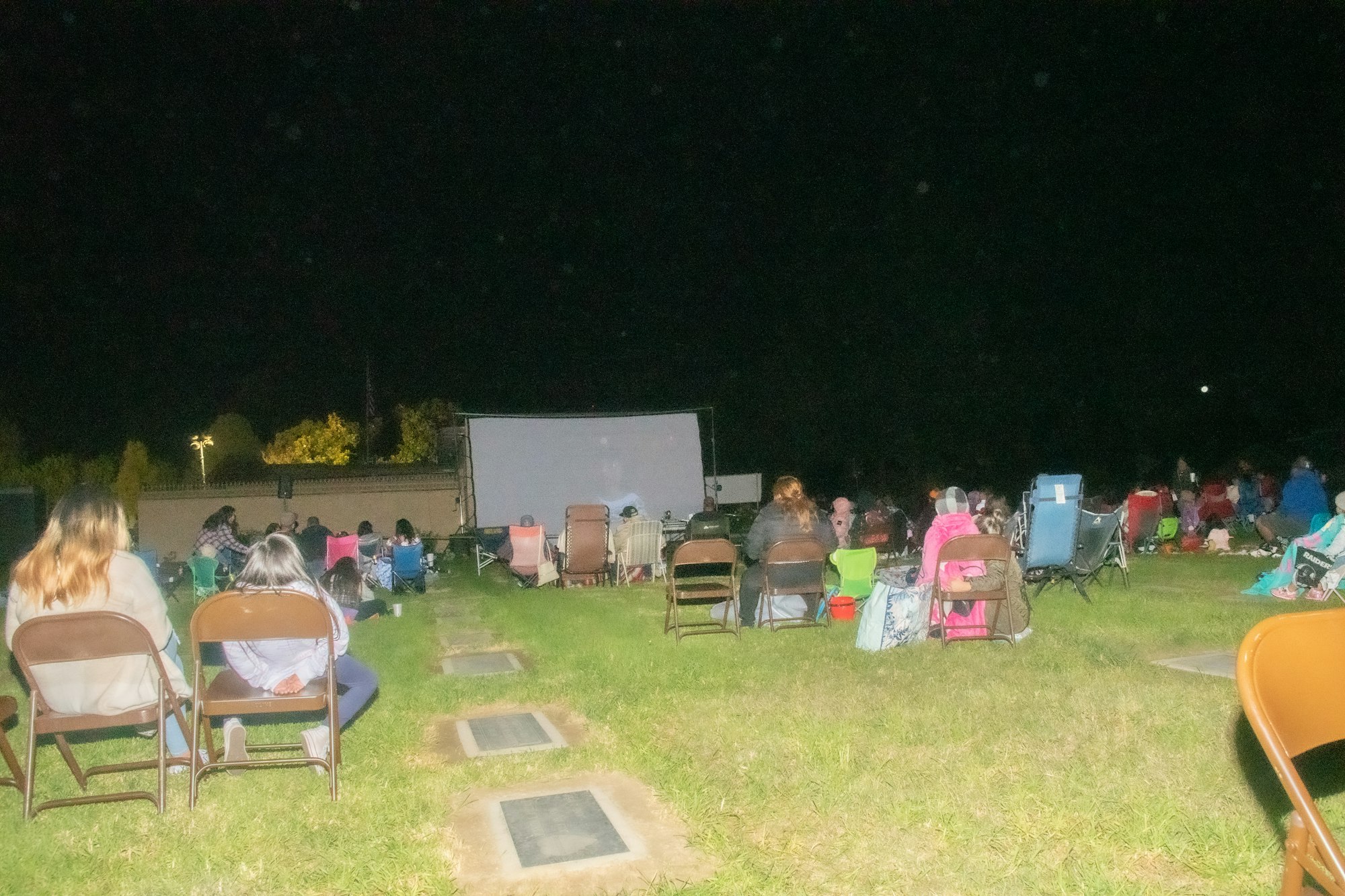 May contain: grass, plant, people, person, lawn, chair, furniture, child, girl, and female