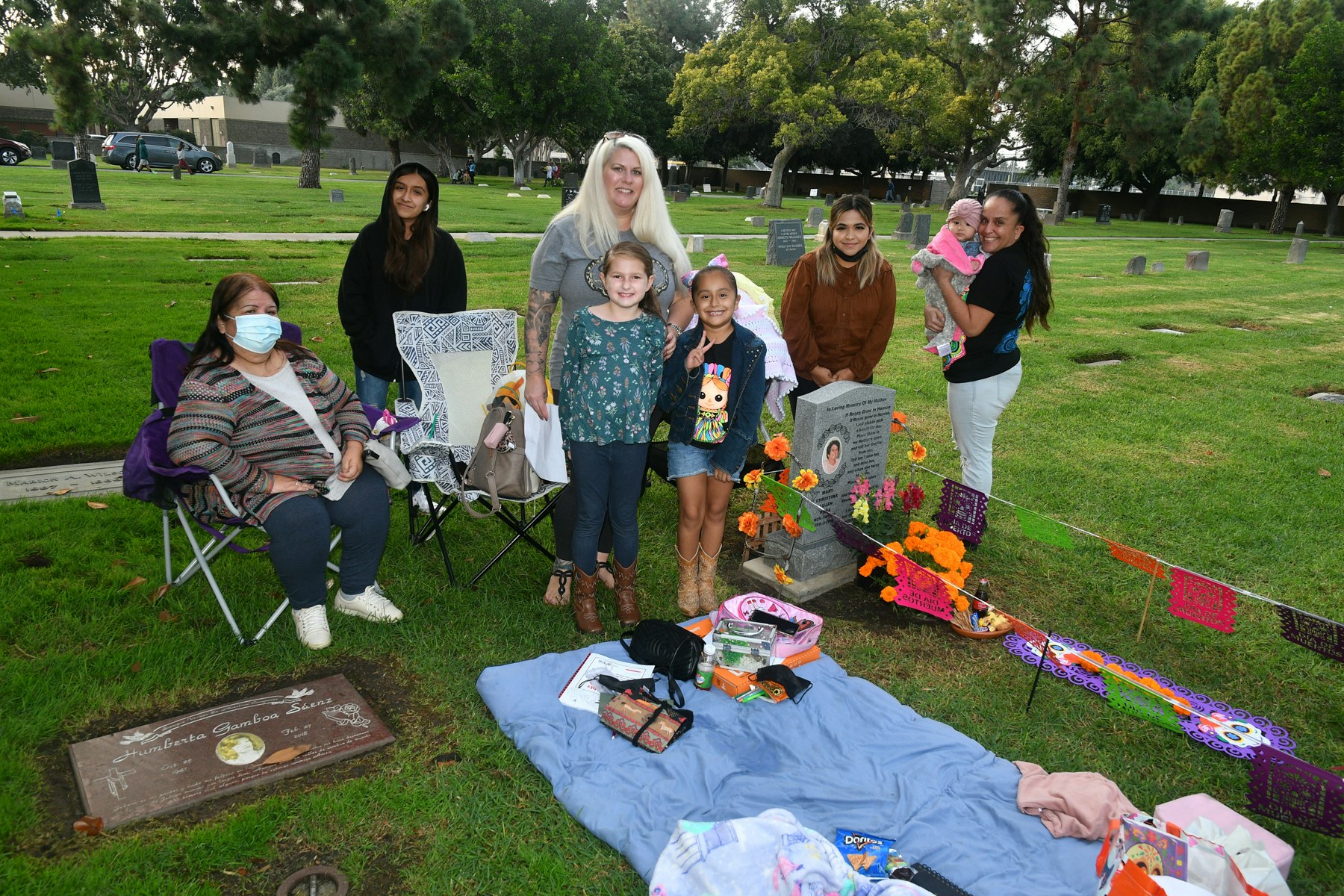 Family gathered around the grave of their love one