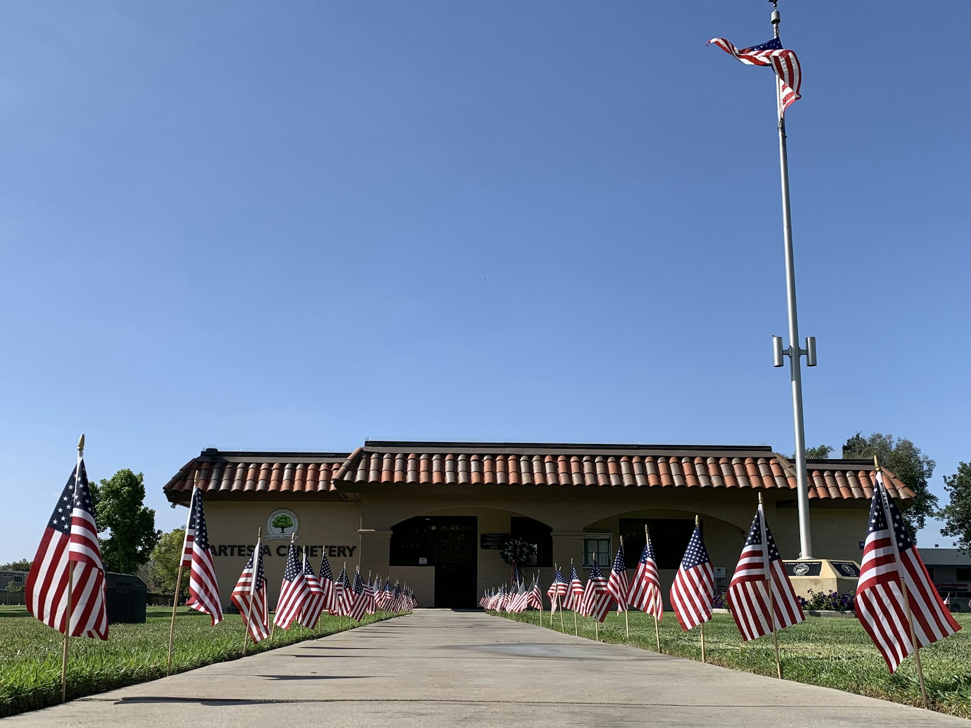 Front picture of cemetery office building with flags