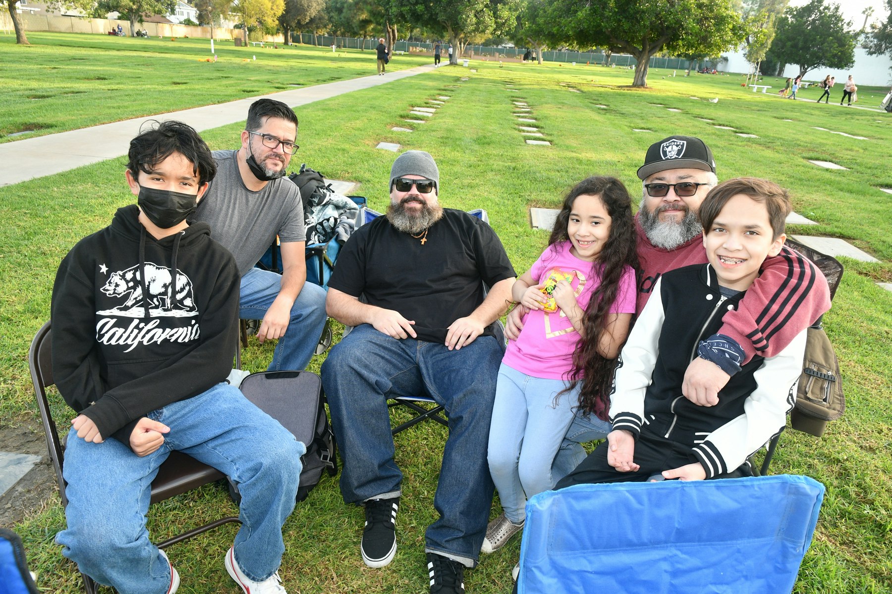 Family gathered around the grave of their love one