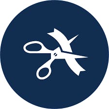 White ribbon and scissors icon on a dark blue circle background.