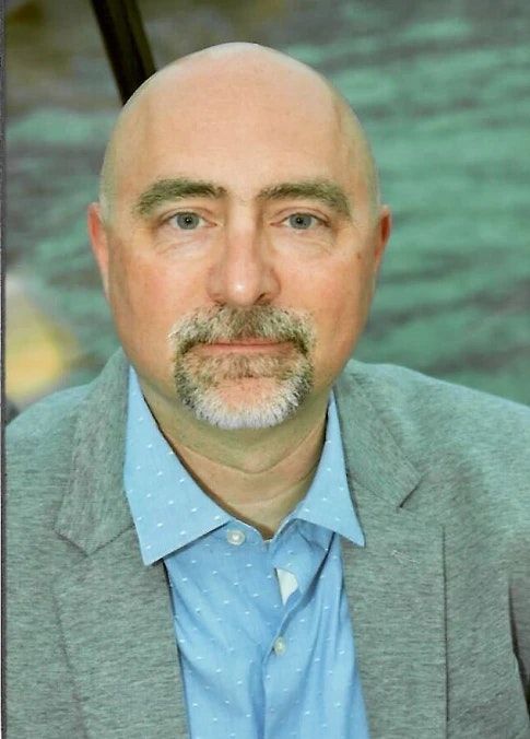 Man in gray suit with open blue dress shirt