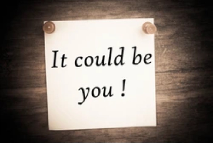 "It could be you!" written on a note held up by push pins