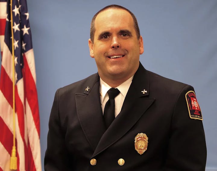 Man in fire officer uniform with American flag