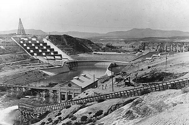 A vintage photo of a dam being constructed