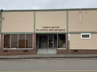 A building for the Coos County Planning Department, featuring a simple façade and entrance with large windows.