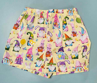 Yellow shorts with colorful gnome prints, Easter-themed decorations, and festive motifs.