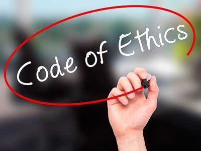 A hand writing "Code of Ethics" in a red circle, suggesting a focus on ethical guidelines or principles.
