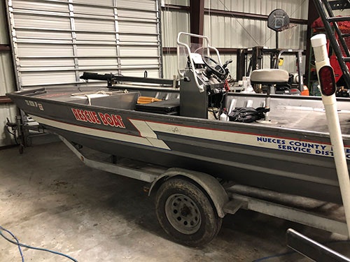 A rescue boat on a trailer inside a garage, labeled "Rescue Boat" and "Nueces County ESD 2".