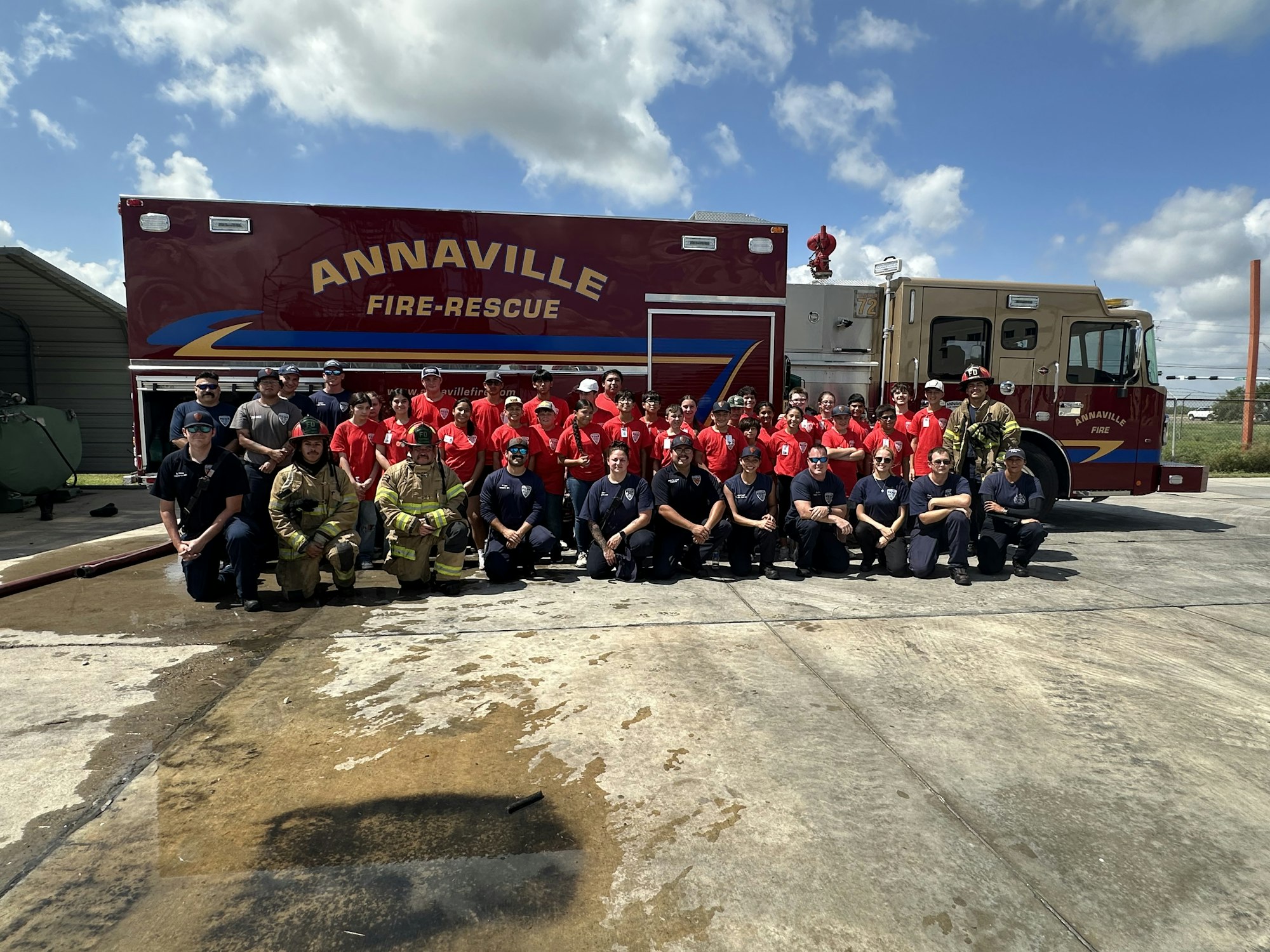 A group of people in uniforms posing in front of an "Annaville Fire-Rescue" truck.