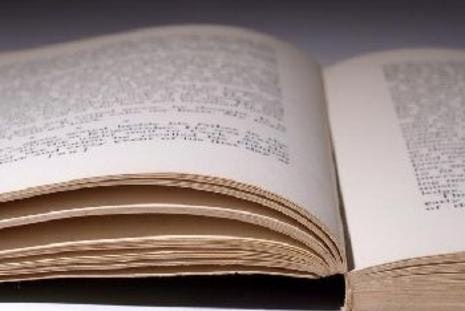 An open book with visible text, close-up on the pages.