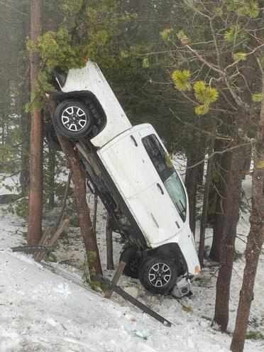 Photo of a vehicle crash: truck in a tree