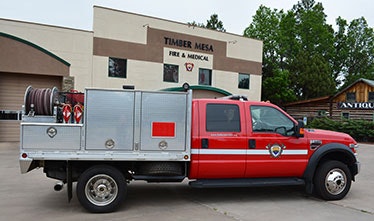 A red fire and medical truck parked in front of the Timber Mesa Fire & Medical building.