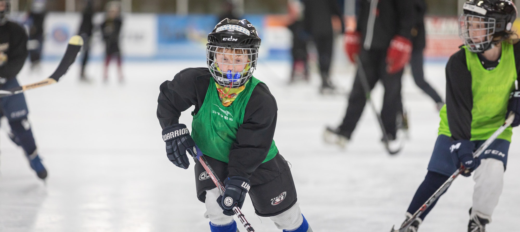 Youth ice hockey players practicing on the rink.