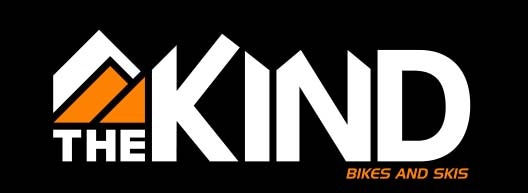 A logo with the text "THE KIND BIKES AND SKIS" with an orange and black mountain design.