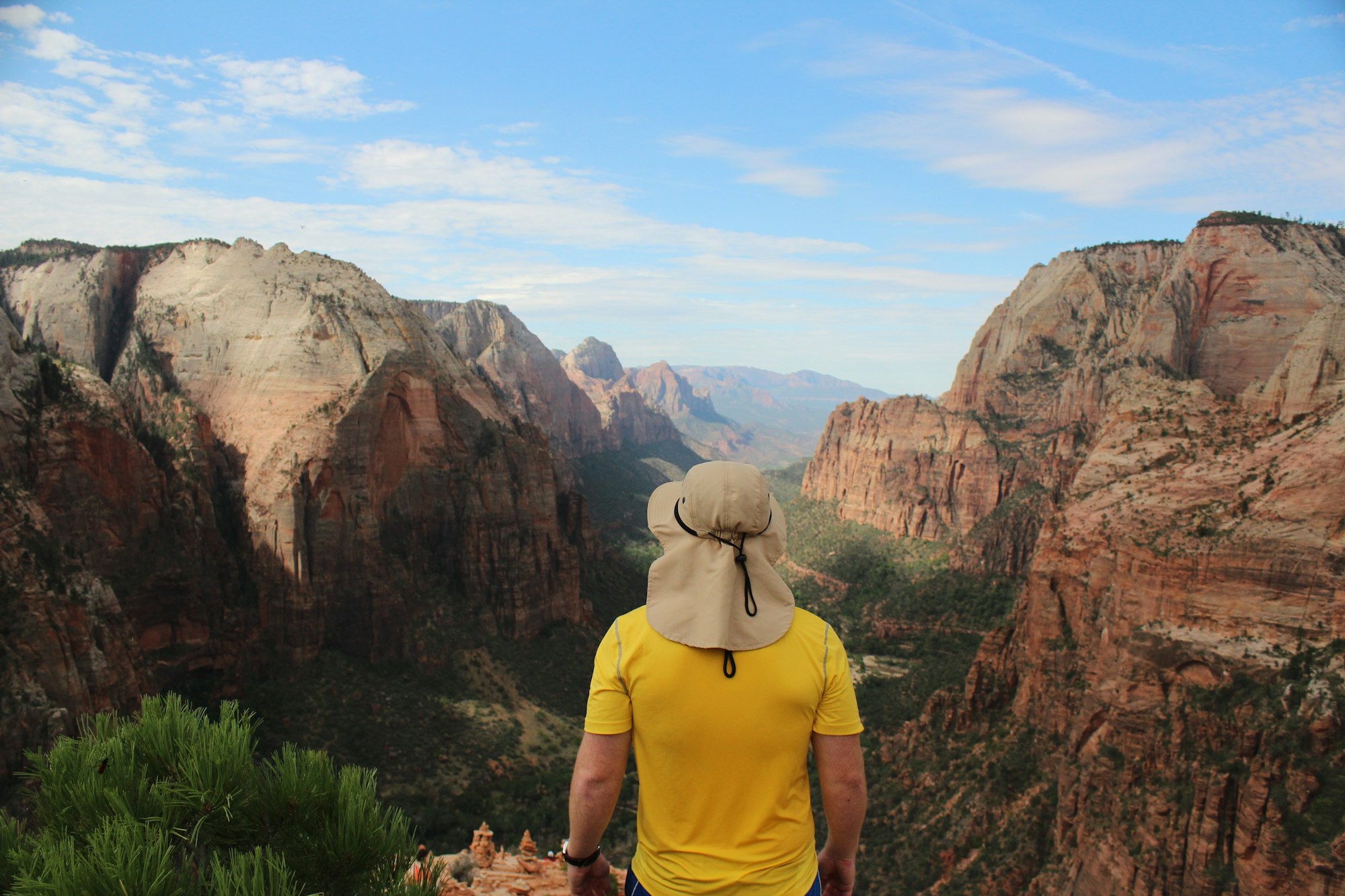 May contain: mountain, nature, outdoors, valley, canyon, person, plateau, adventure, hiking, leisure activities, cliff, clothing, and hat