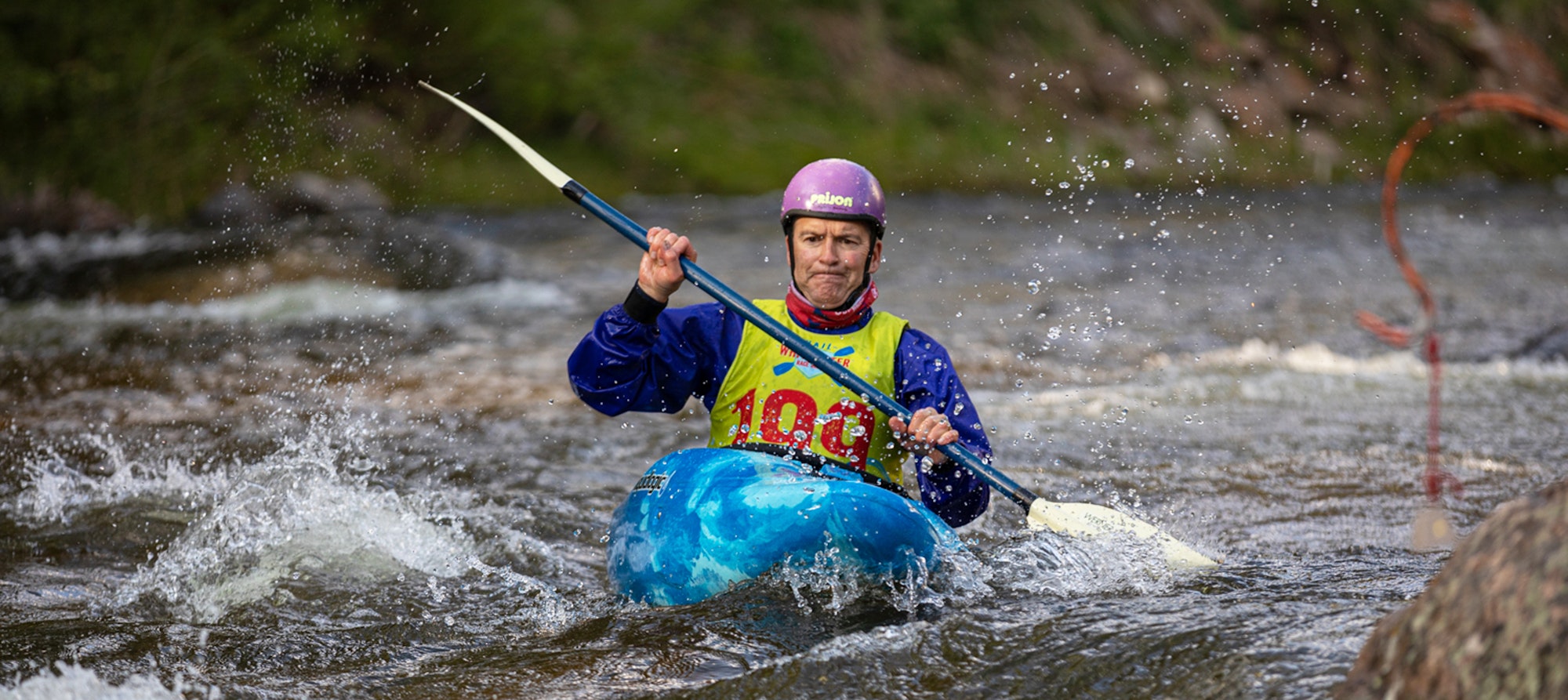 A kayaker navigating through rapids.