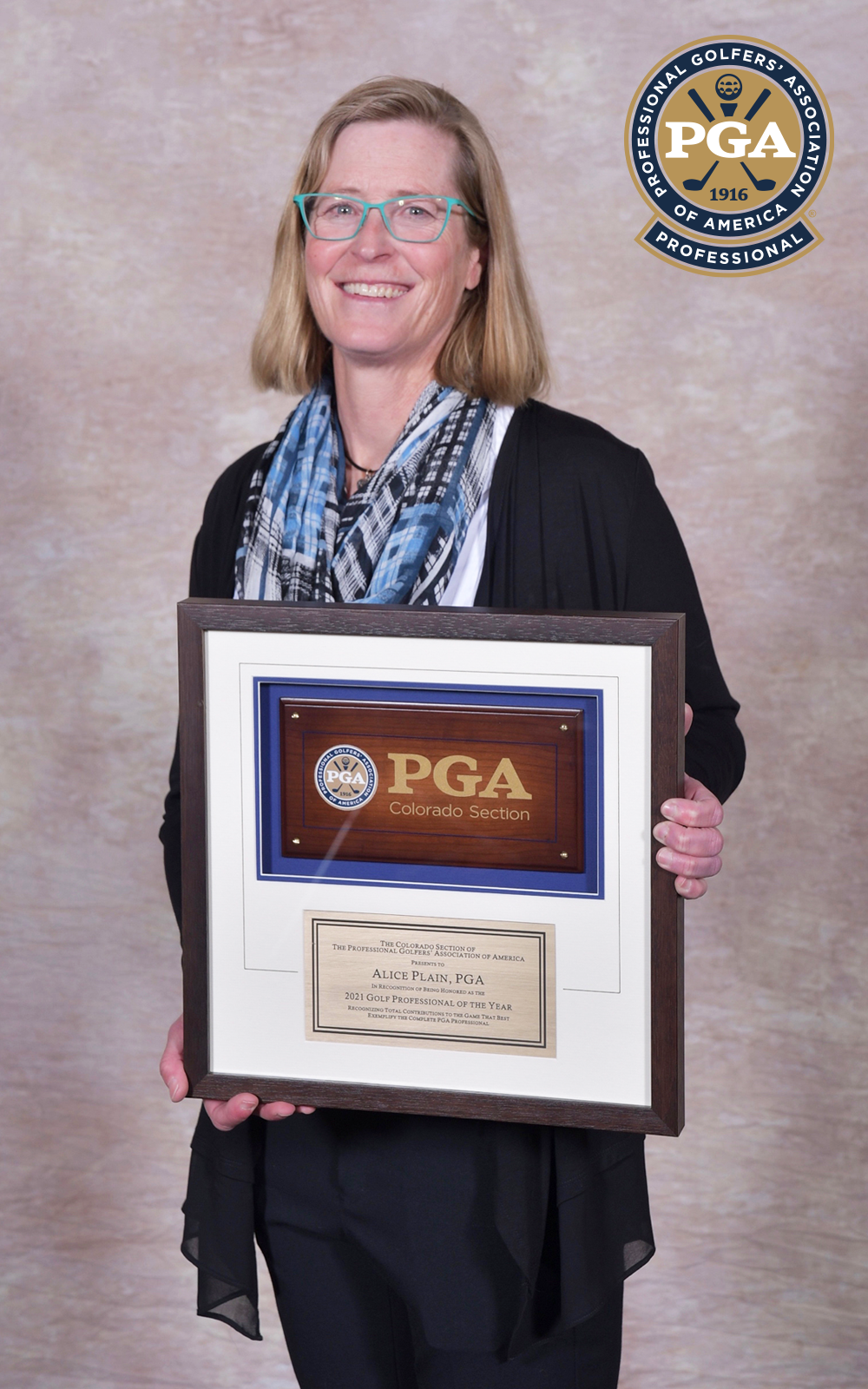 Alice Plain holding a PGA award for '2021 Golf Professional of the Year'.