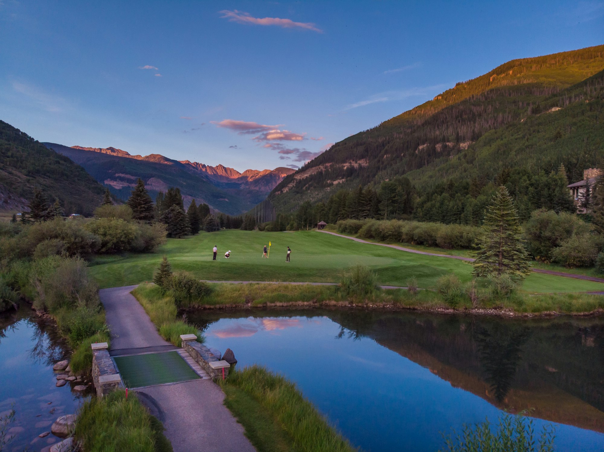 May contain: field, nature, outdoors, person, golf, golf course, sport, lake, and water