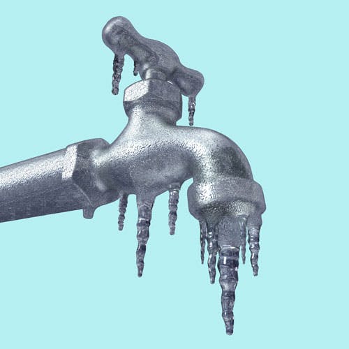 A faucet with icicles hanging from it, against a light blue background.