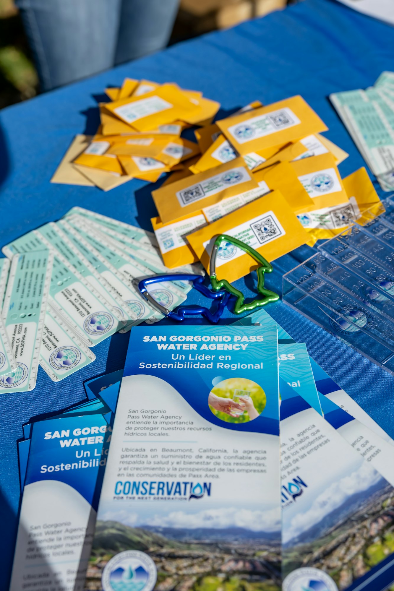 Brochures and yellow packets on a table, featuring "San Gorgonio Pass Water Agency" and conservation info.