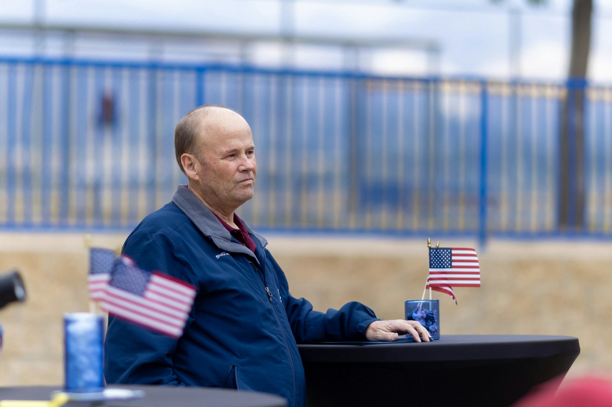 May contain: flag, adult, male, man, and person