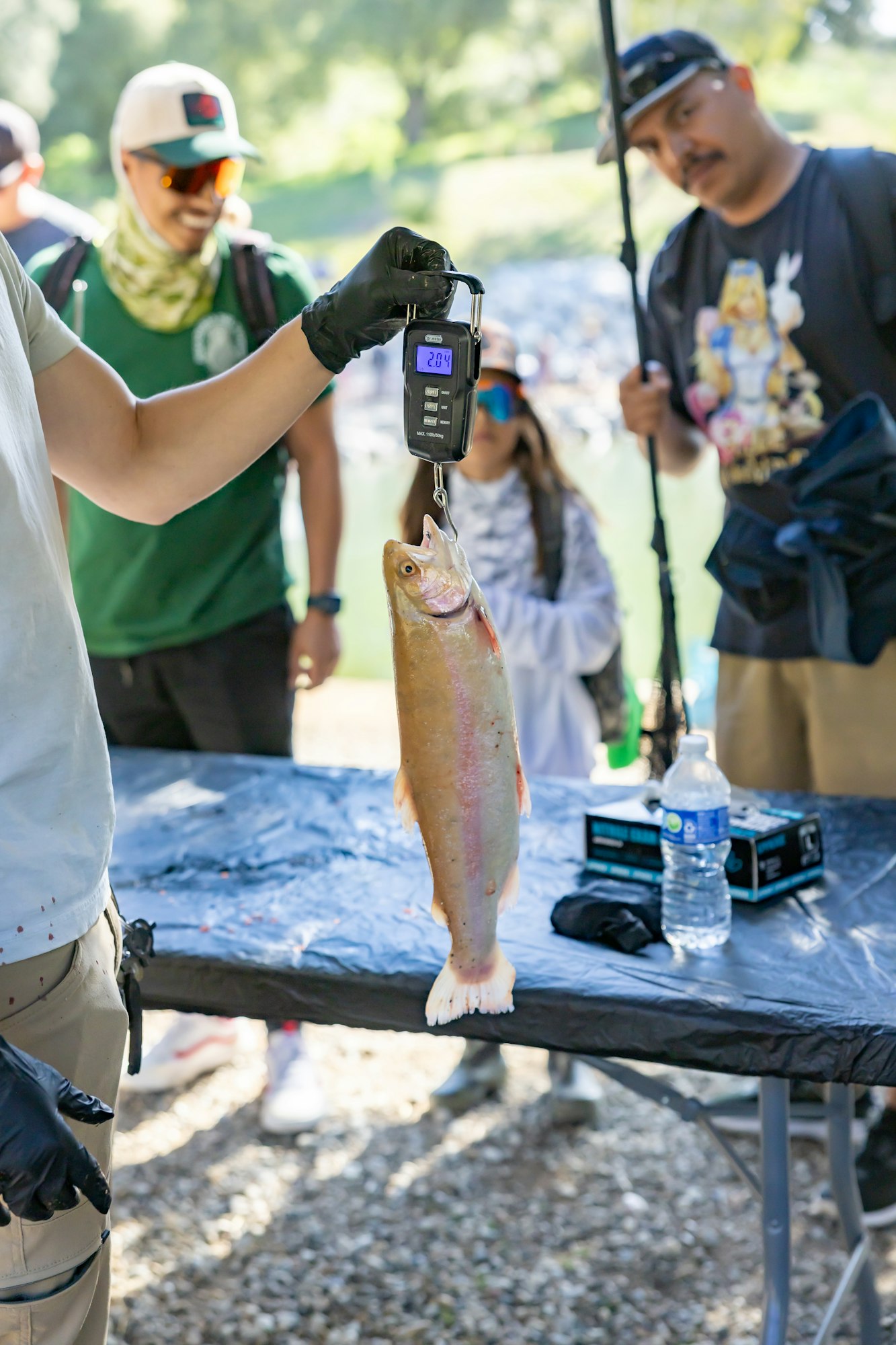 May contain: clothing, glove, person, animal, fish, sea life, hat, accessories, glasses, baseball cap, cap, footwear, shoe, bag, handbag, trout, and wristwatch