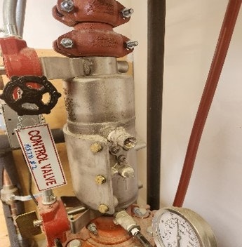 An industrial control valve with gauges and piping.