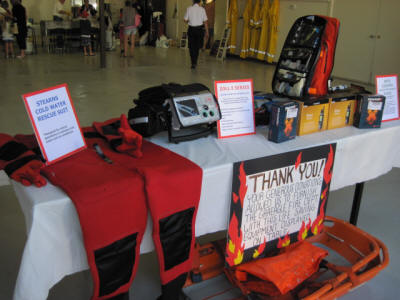 A display table with emergency medical equipment and a "Thank You" sign, possibly at a health or safety event.