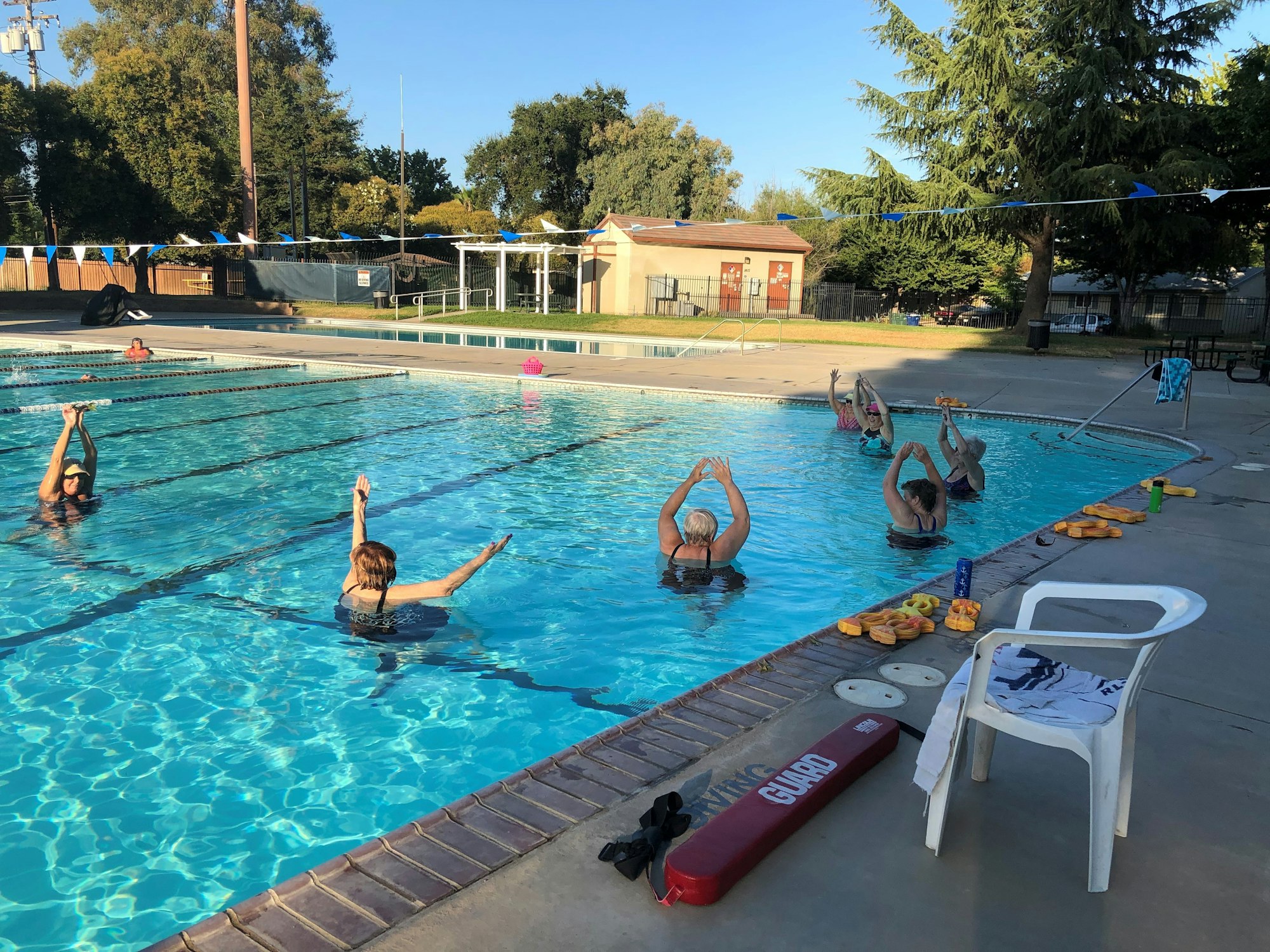 May contain: water, chair, furniture, pool, swimming pool, leisure activities, person, sport, swimming, water sports, car, transportation, vehicle, and outdoors