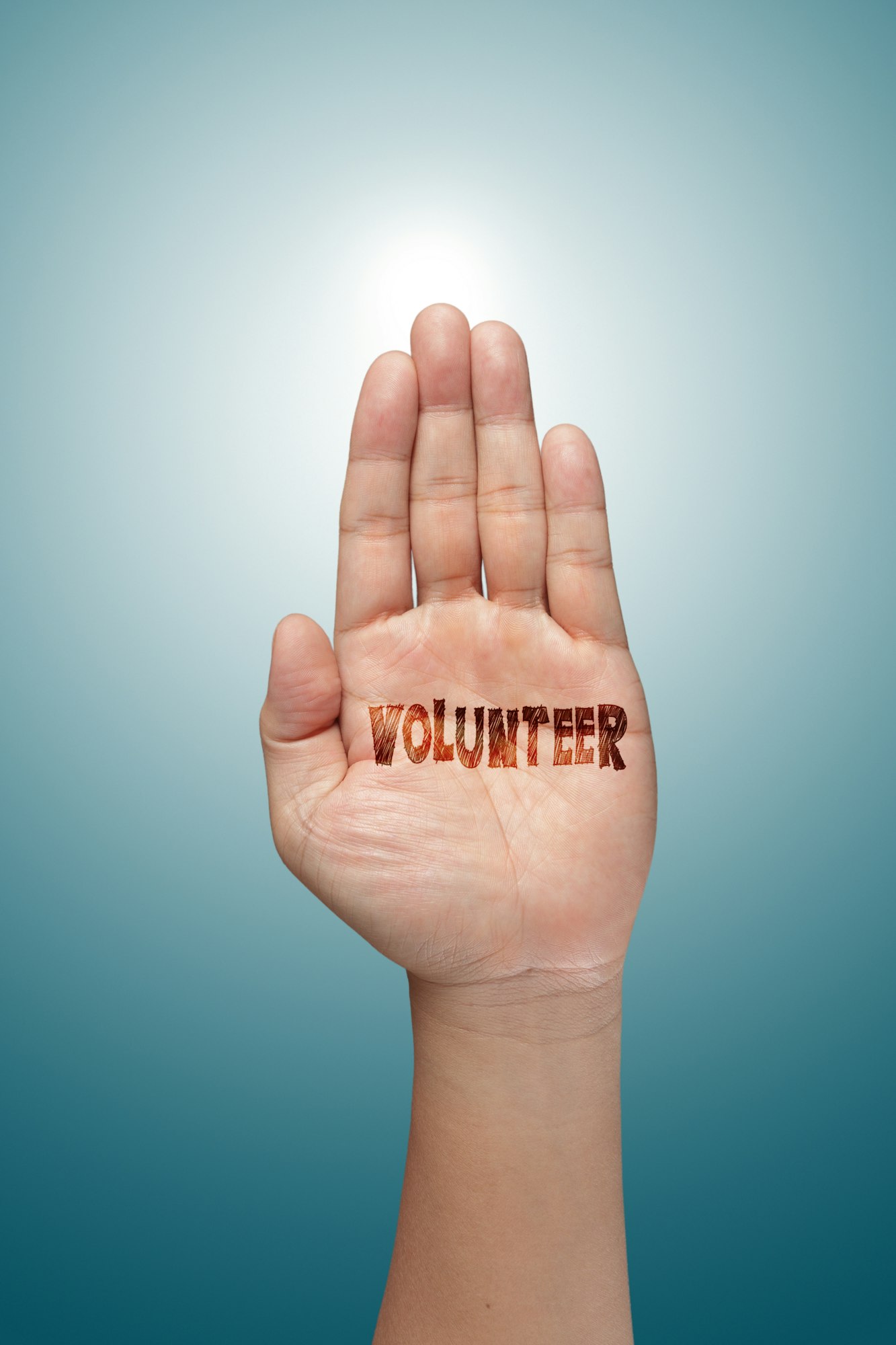 An open hand with the word "VOLUNTEER" stamped on it.