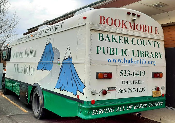Baker County Public Library bookmobile with slogans and contact information.