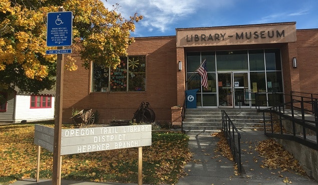 Image of front of library, grass and trees