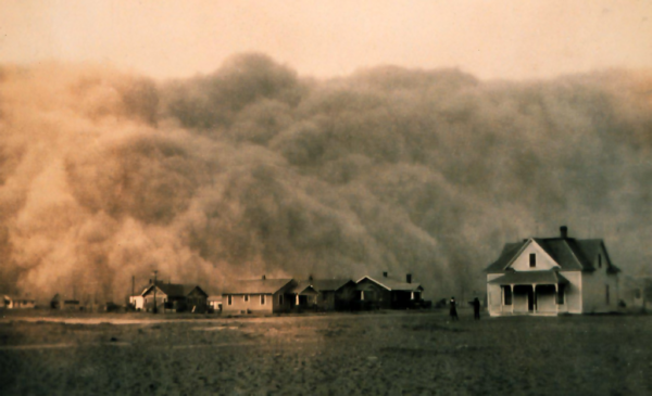 A massive dust storm approaches a row of houses, creating an ominous and dramatic scene.
