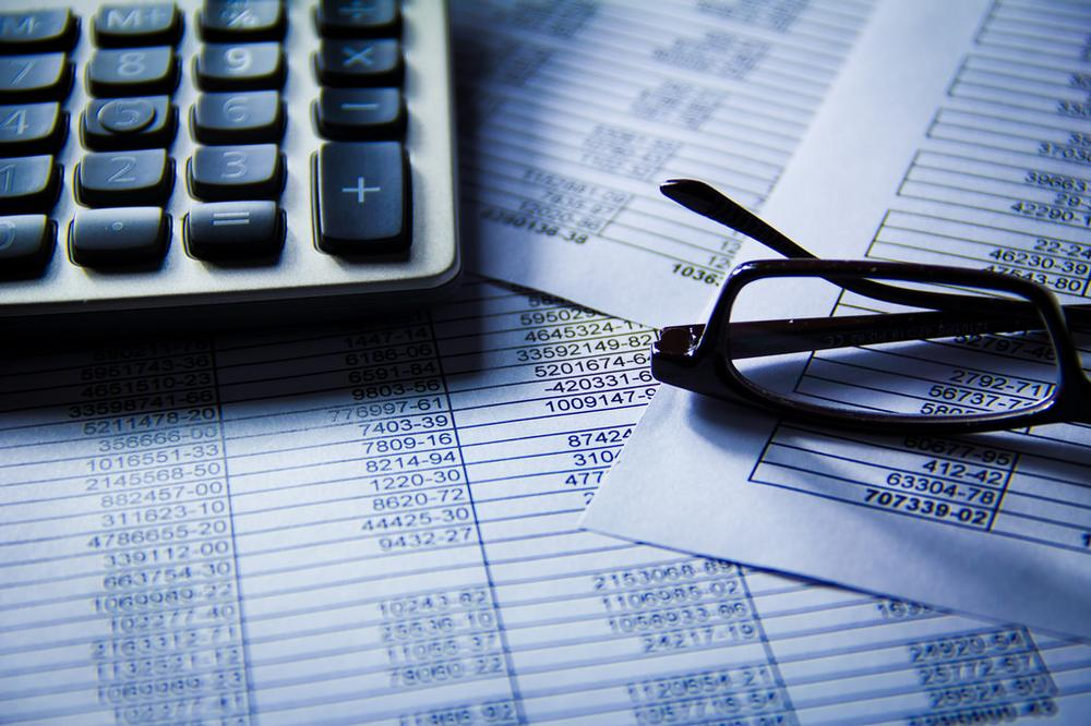 Calculator and glasses laying on documents