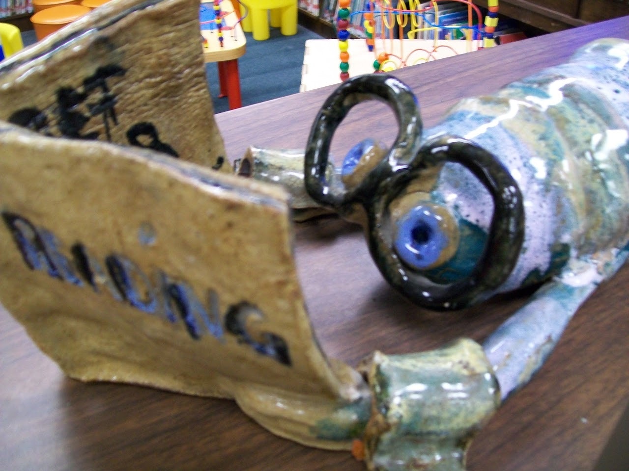 Ceramic Bookworm statue located in children's section of Library. Created by Evelyn Roberts and donated in her memory by her family September 1989.