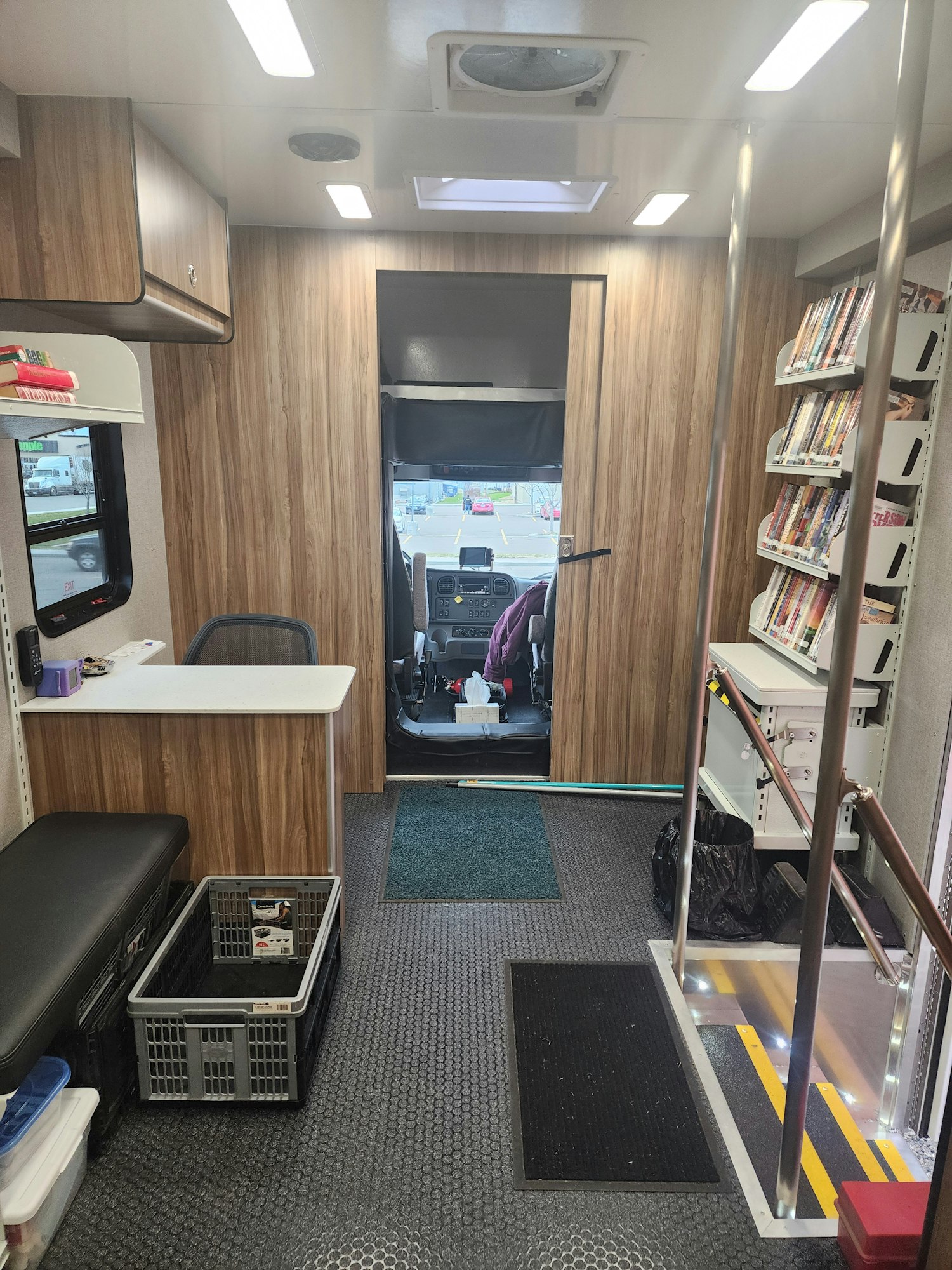 Interior of the new Bookmobile showing seats, a countertop, books and various items.