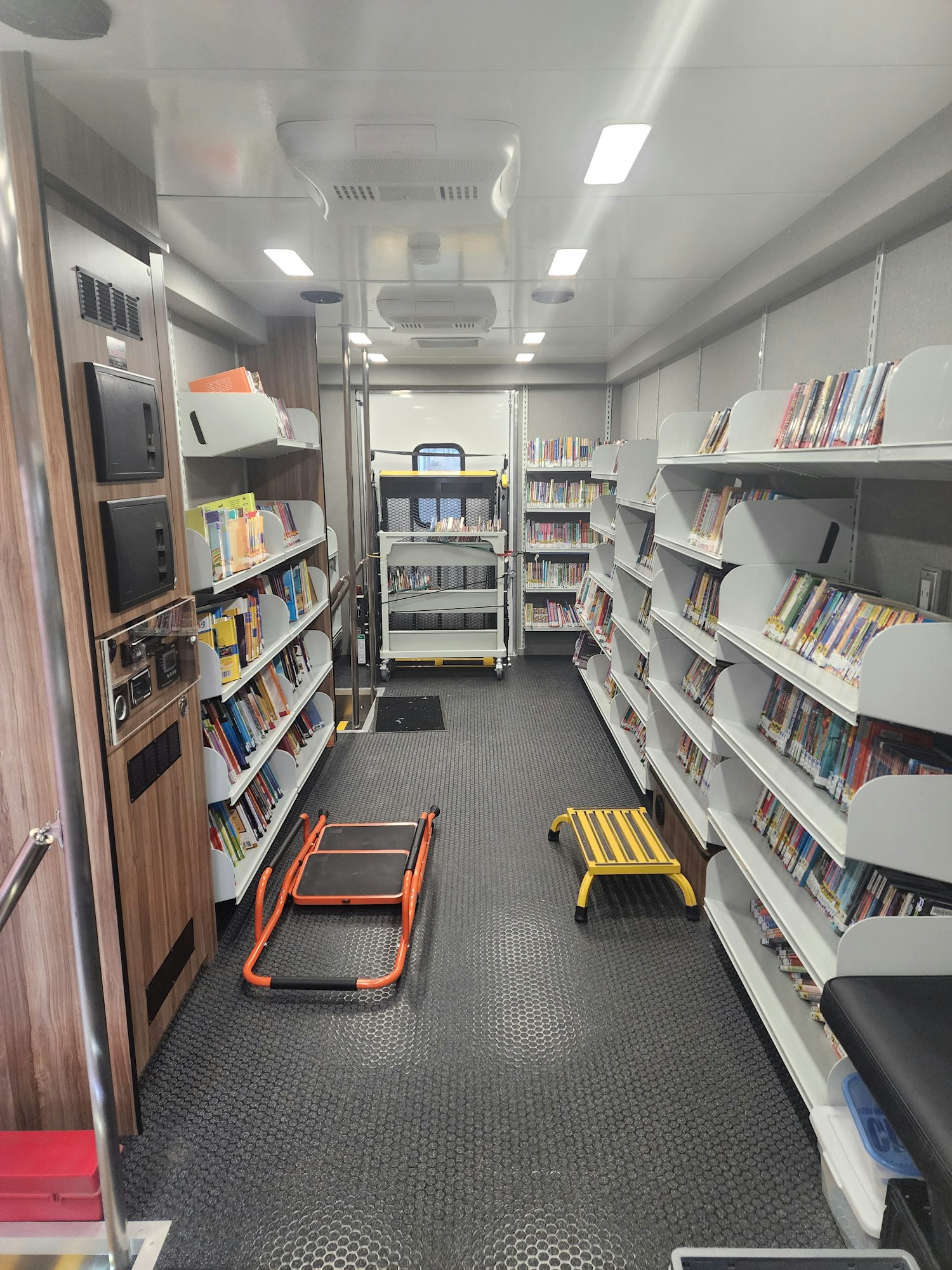 Interior of new Bookmobile showing books, décor, and other library related materials.