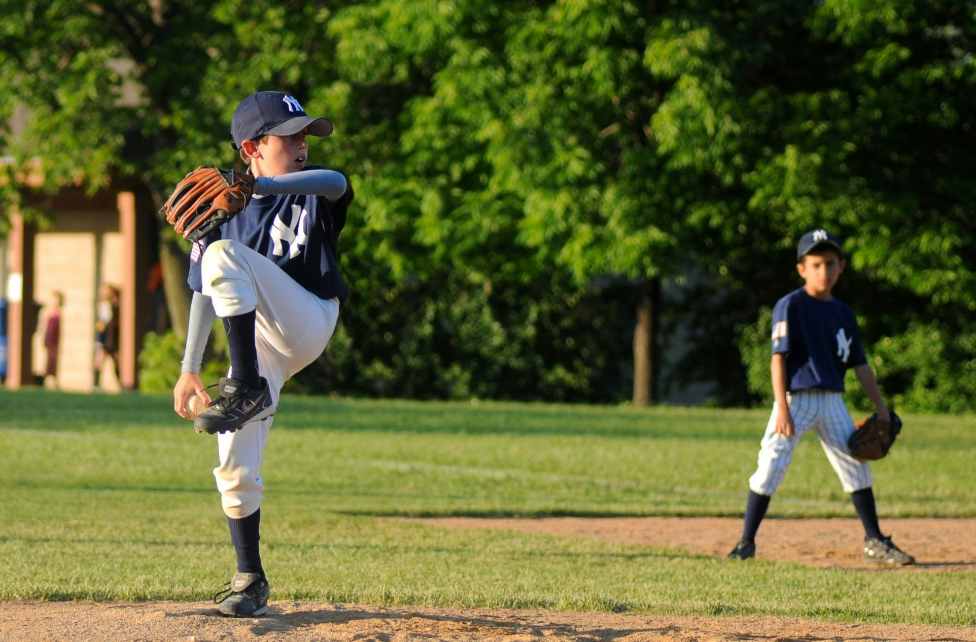 May contain: clothing, apparel, person, human, sports, team sport, sport, softball, people, glove, team, baseball, and baseball glove