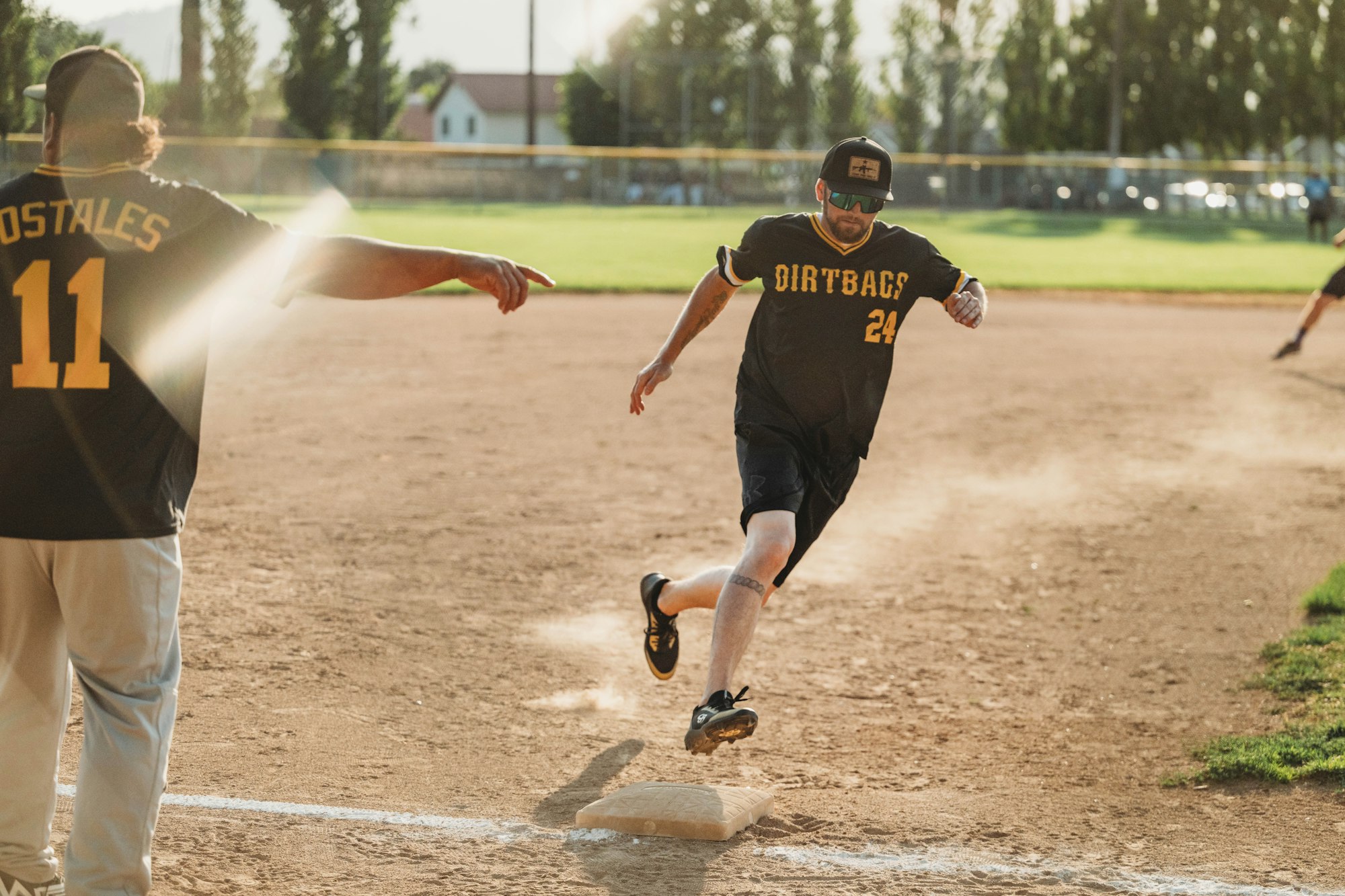 A baseball game in progress with a player running bases.