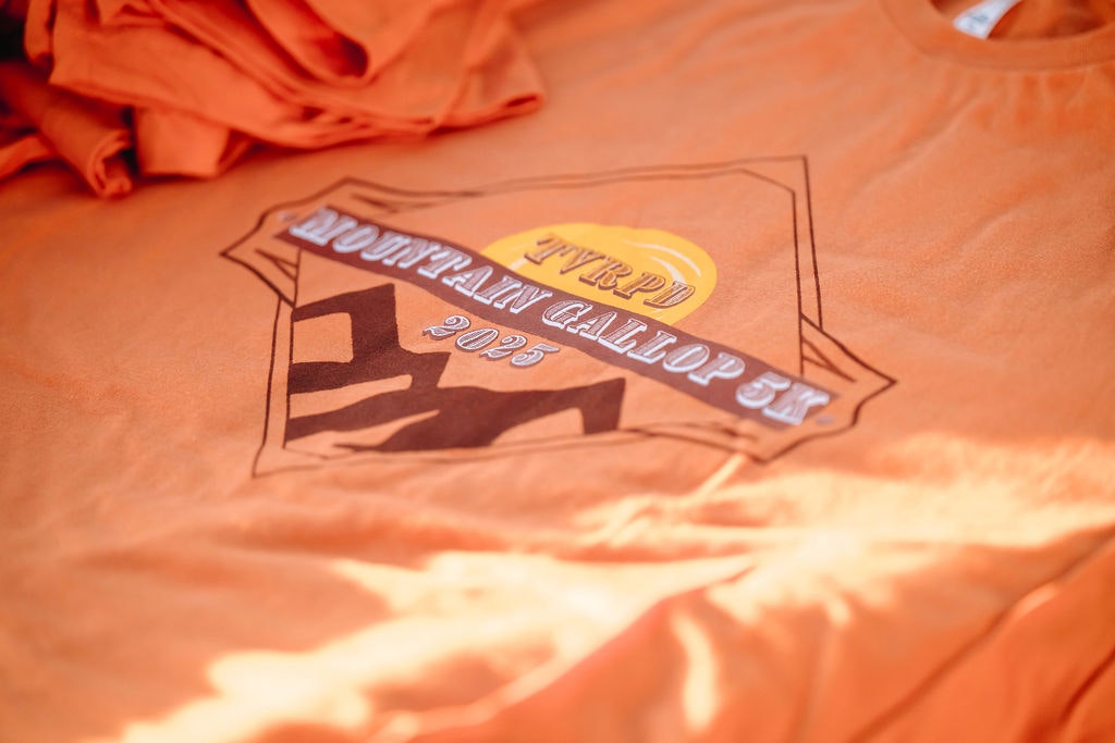 Orange T-shirt with "TTYPD Mountain Gallop 5K 2023" logo/design.