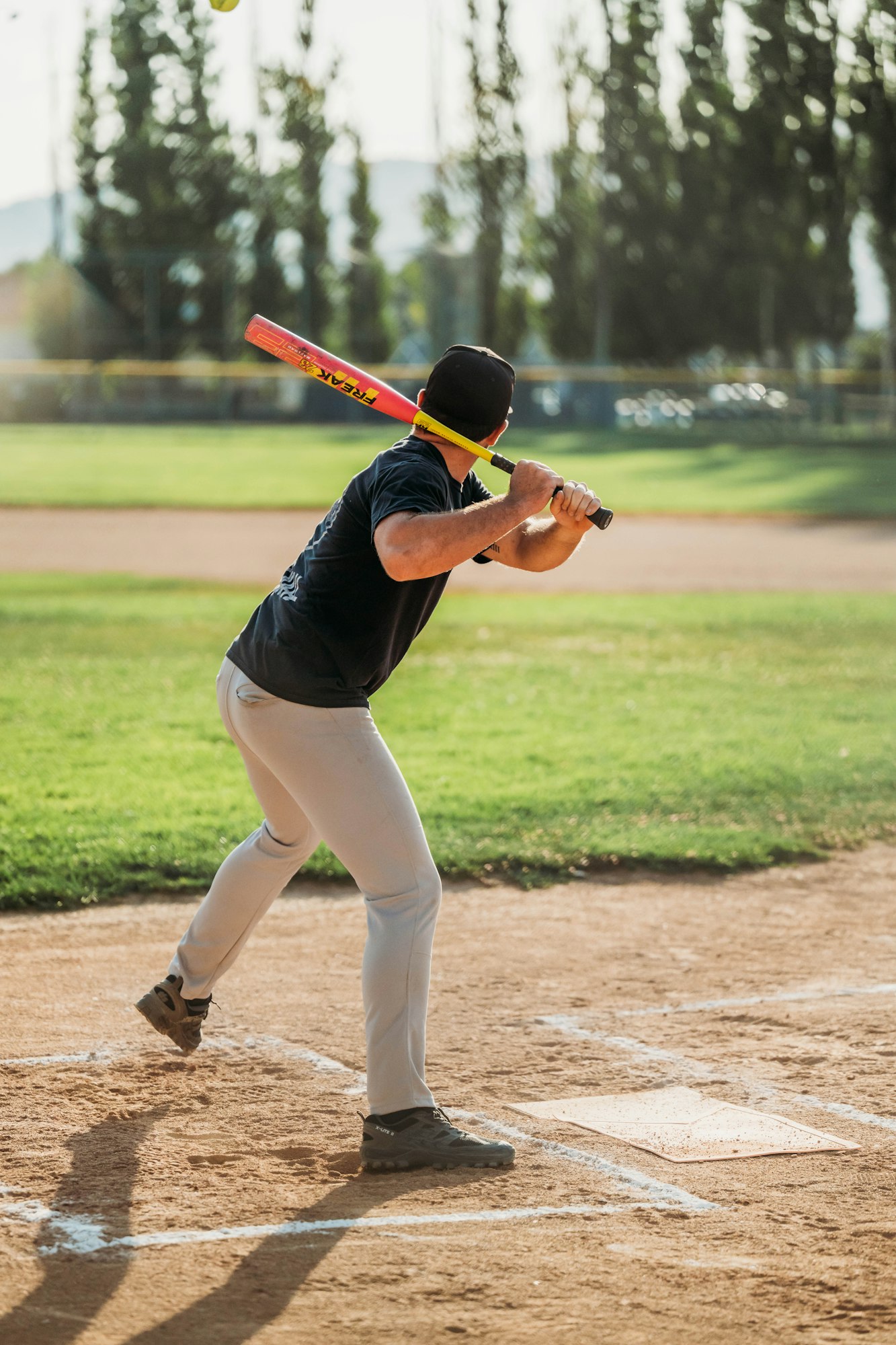 A baseball player swinging a bat at a baseball field.