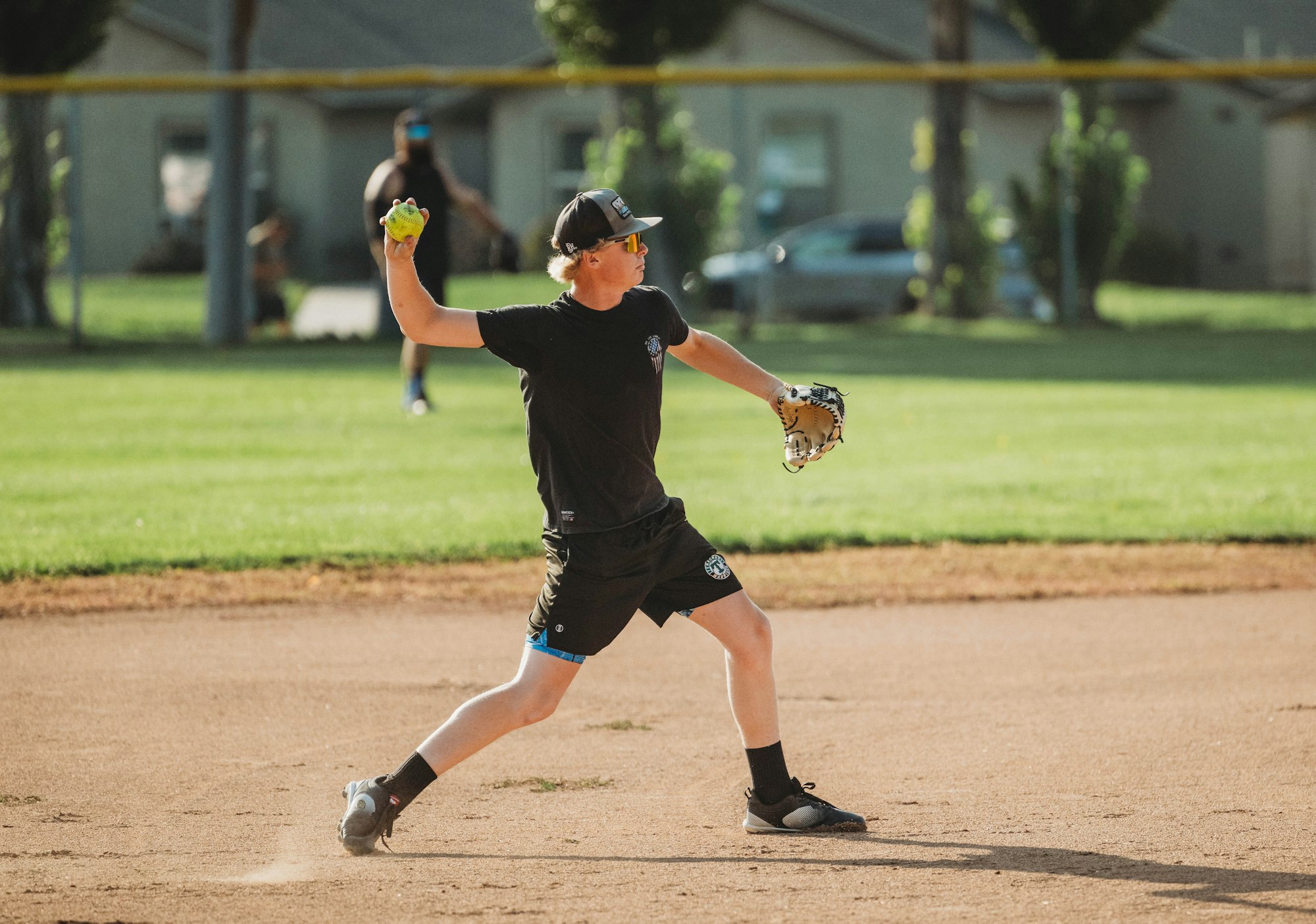 A person playing baseball, about to throw a ball.