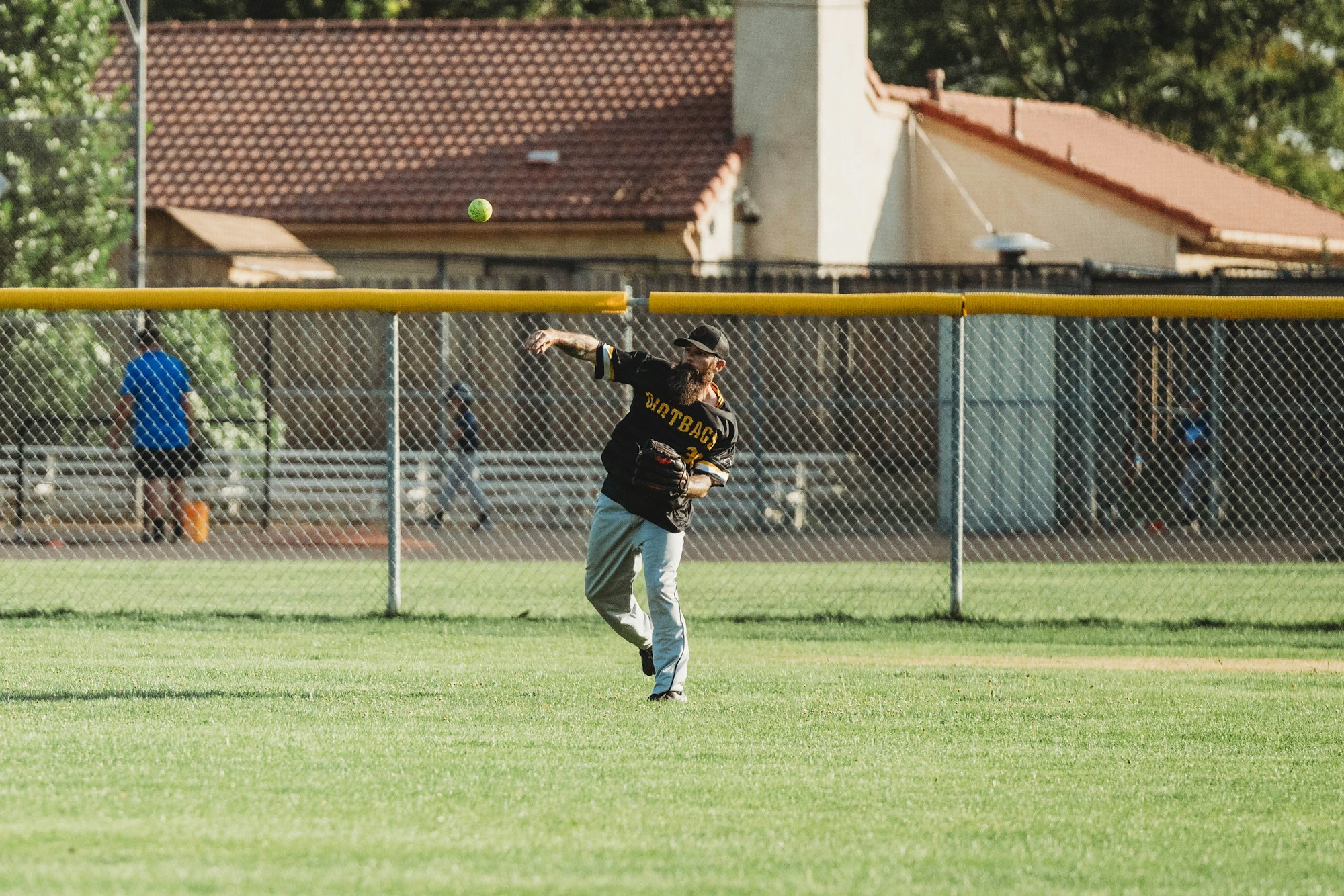 A baseball player throwing a ball in a field.