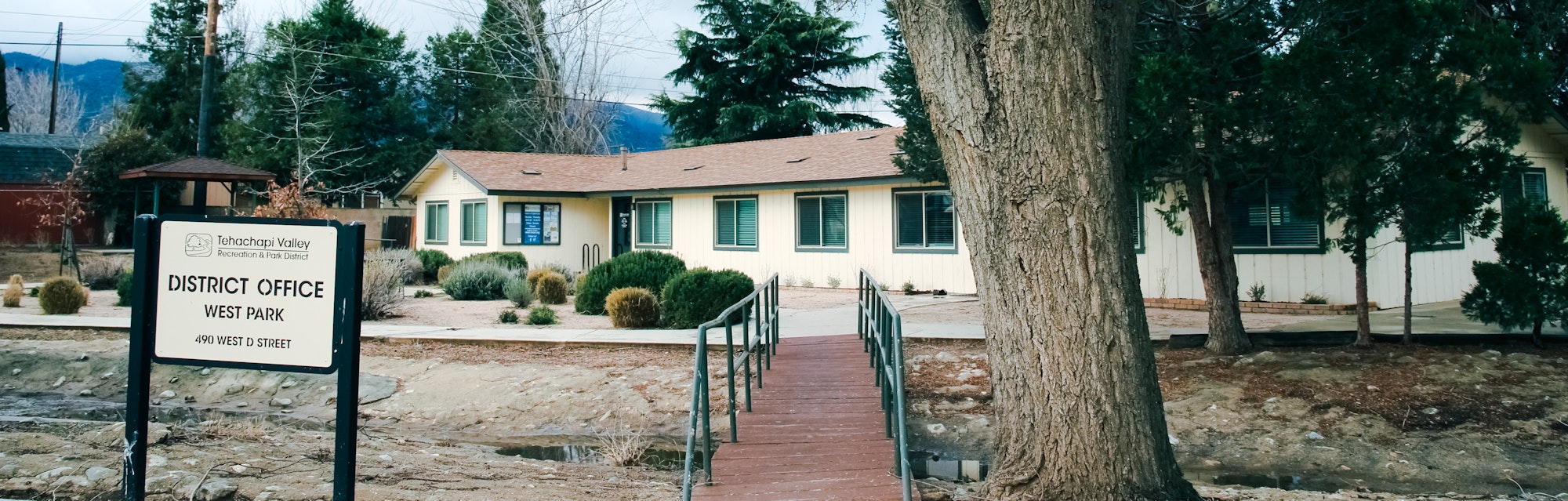 District office building amidst trees with a sign for Tehachapi Valley Recreation & Park District, West Park.