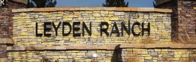 Stone entrance sign reading "Leyden Ranch."