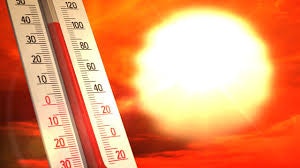 A thermometer indicating high temperatures with a bright sun in the background.