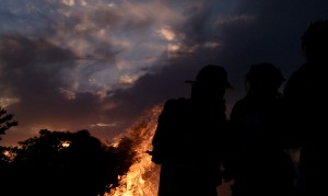 Photo of firefighters in front of a fire