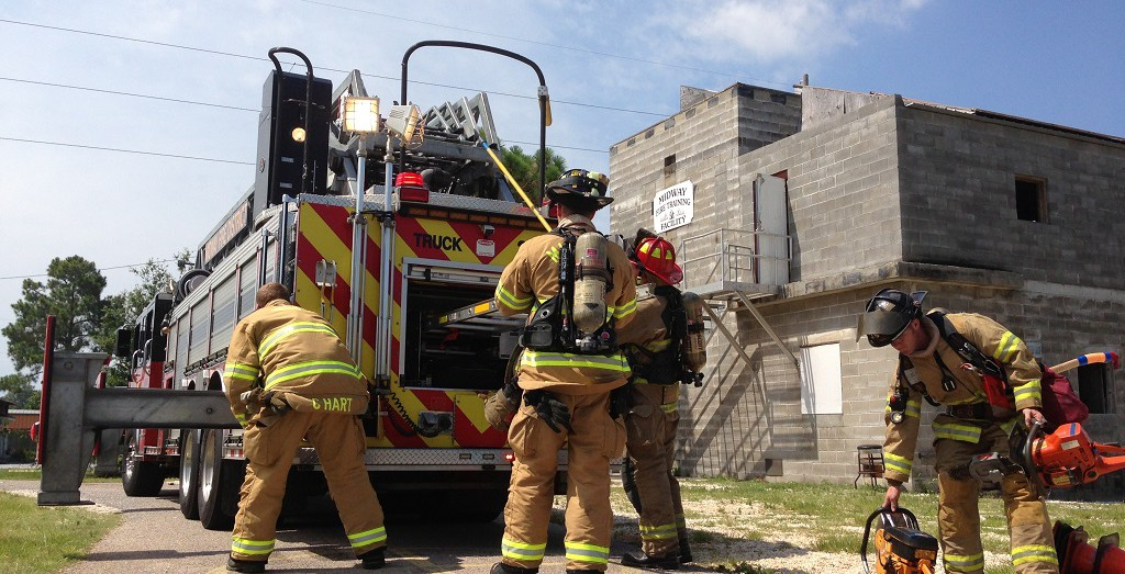 Photo of firefighters and a truck