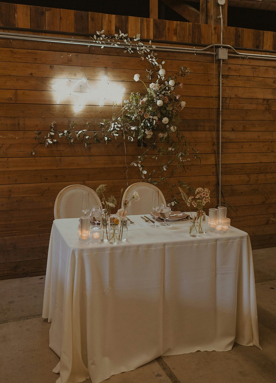 May contain: indoors, interior design, tablecloth, flower, flower arrangement, plant, furniture, table, tabletop, wood, and flower bouquet